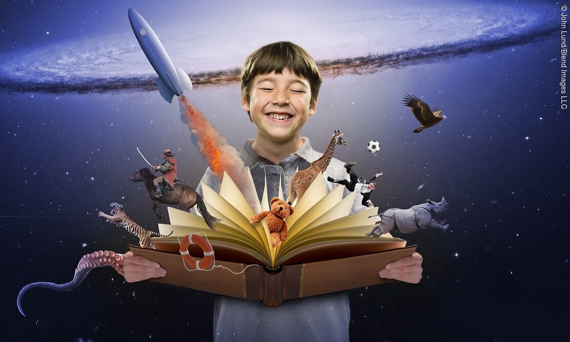 Surprised boy watching colorful characters fly out of open book