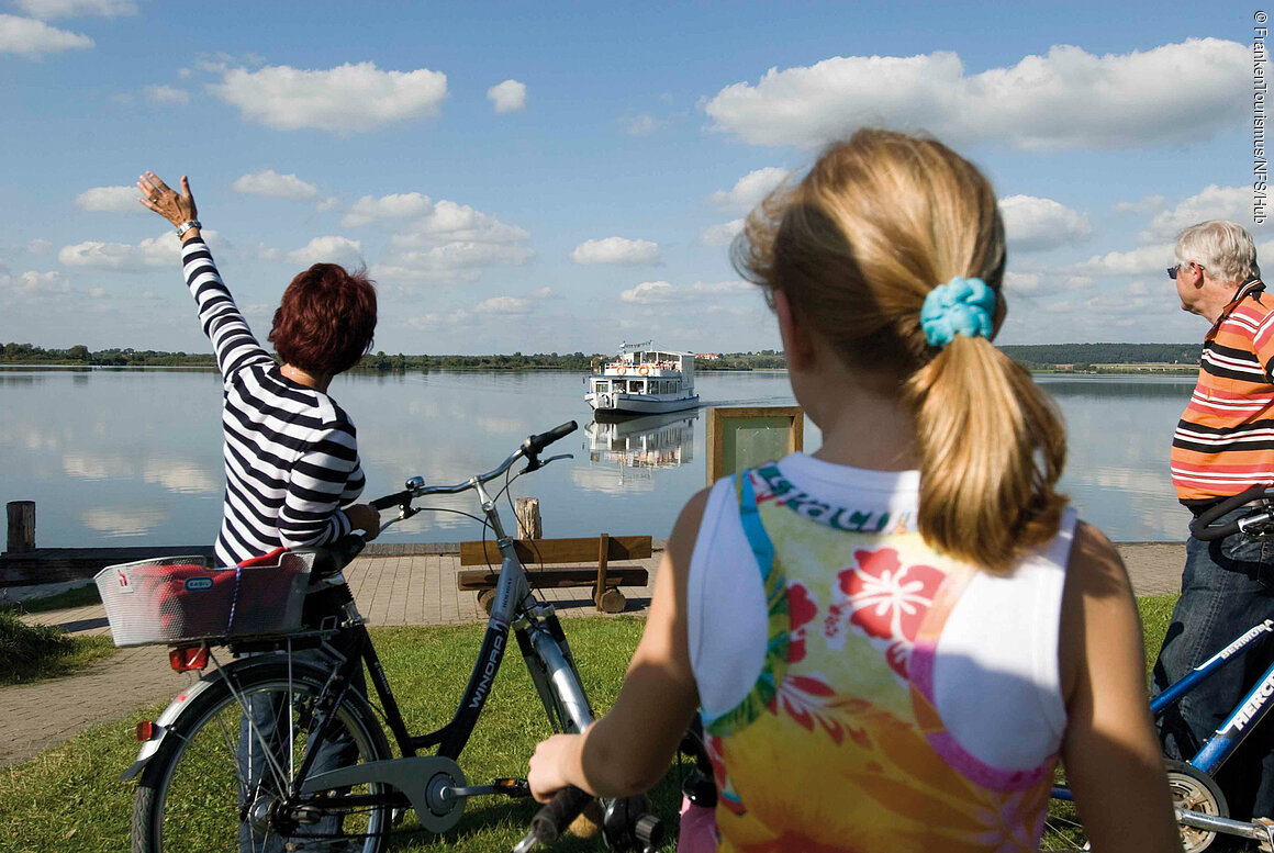 Fränkisches Seenland, Radler vor der MS Altmühlsee Radler mit der "MS Altmühlsee" im Hintergrund